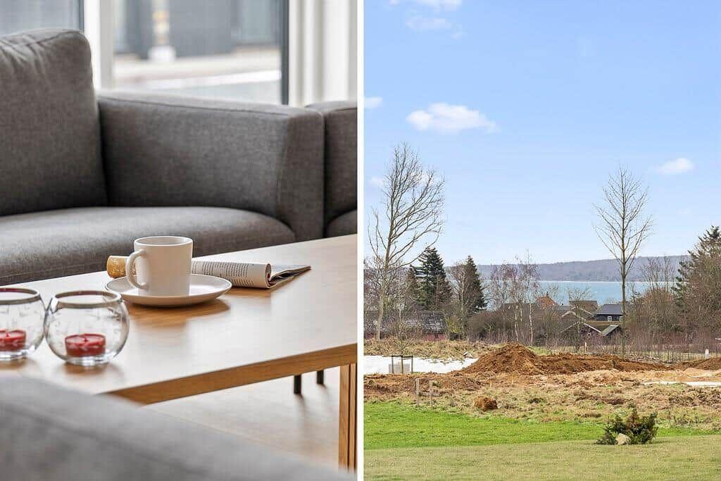 Wohnzimmer mit Couch und Tisch. Blick auf Grünfläche und See.