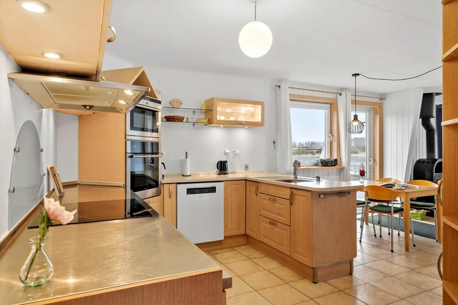 Kitchen with wooden cabinets, sink, and view of water
