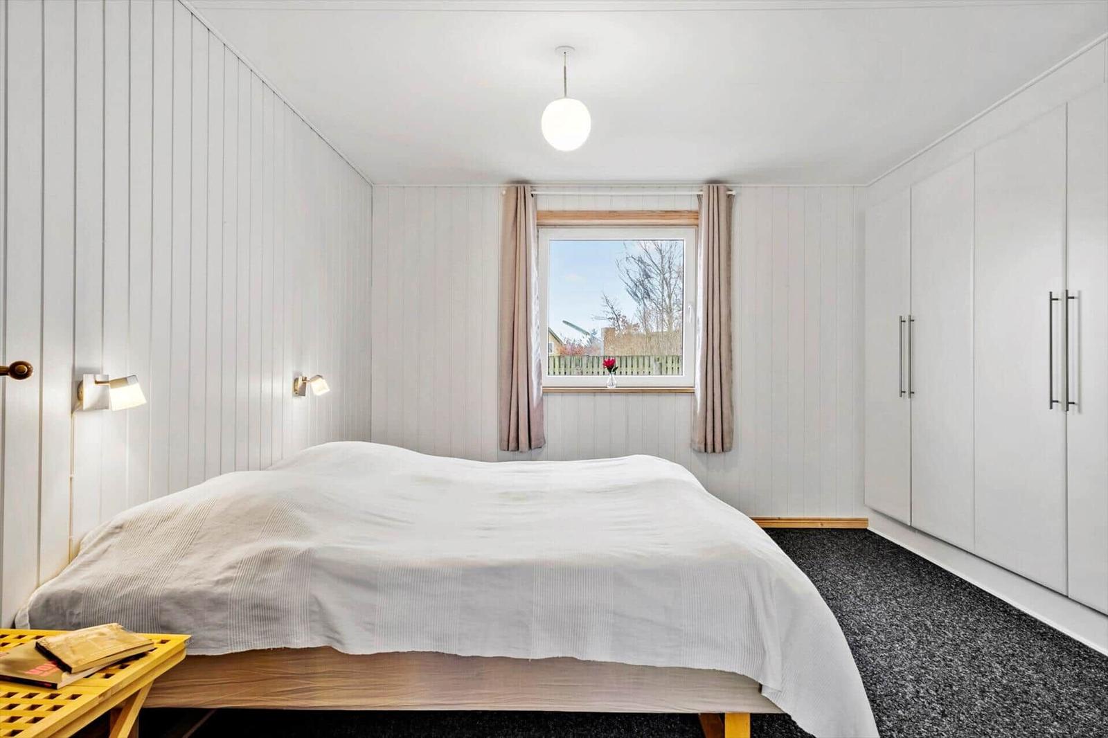 Bedroom with bed, window, and closet.