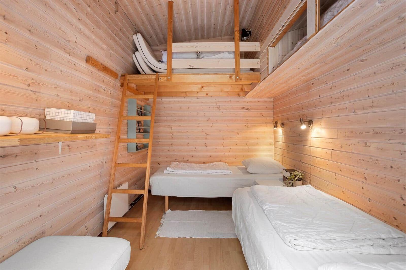 Room with two beds and a loft bed with ladder.