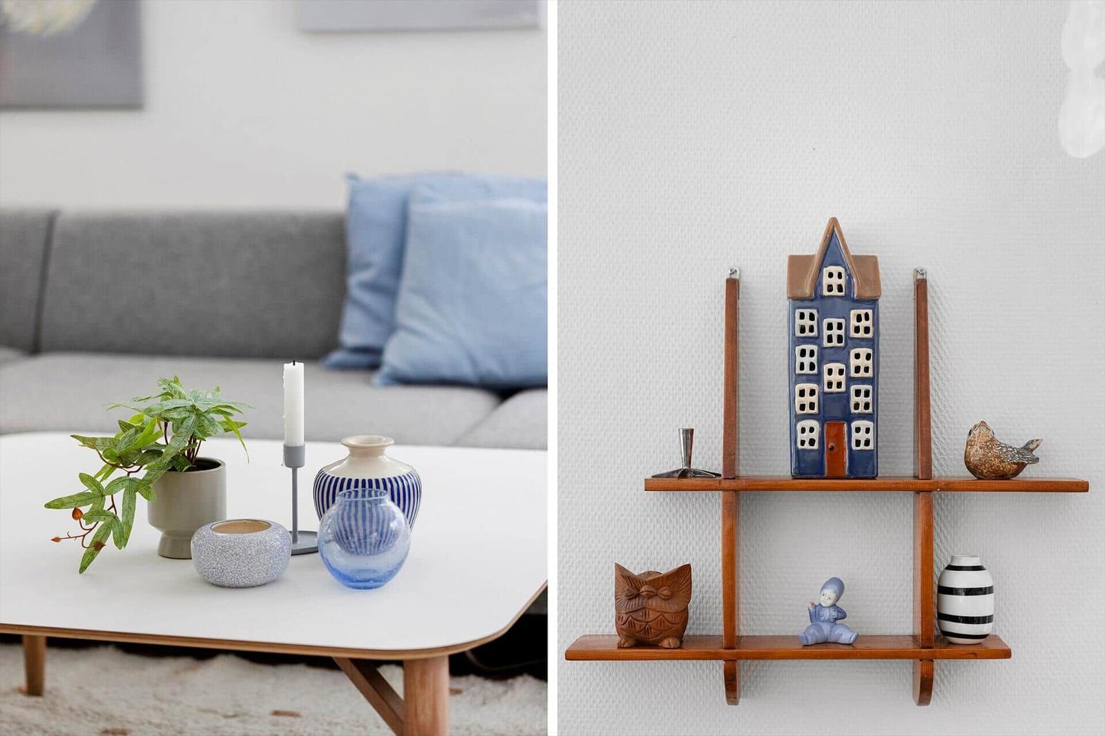 Living room with sofa, table, and decor. Wall shelf with figurines and vases.