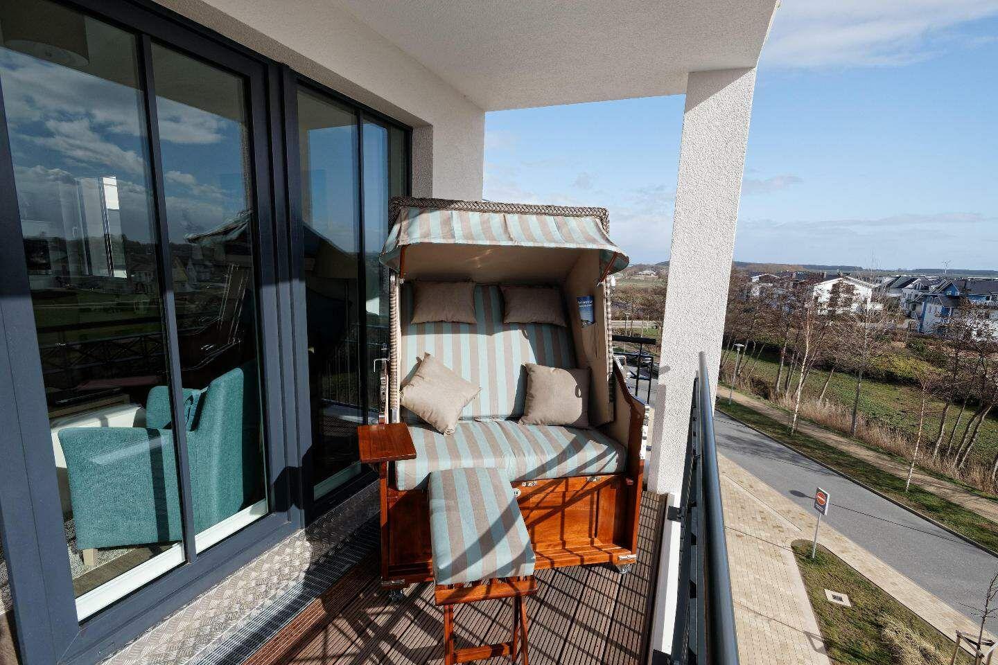 Balcony with beach chair and view of residential area.