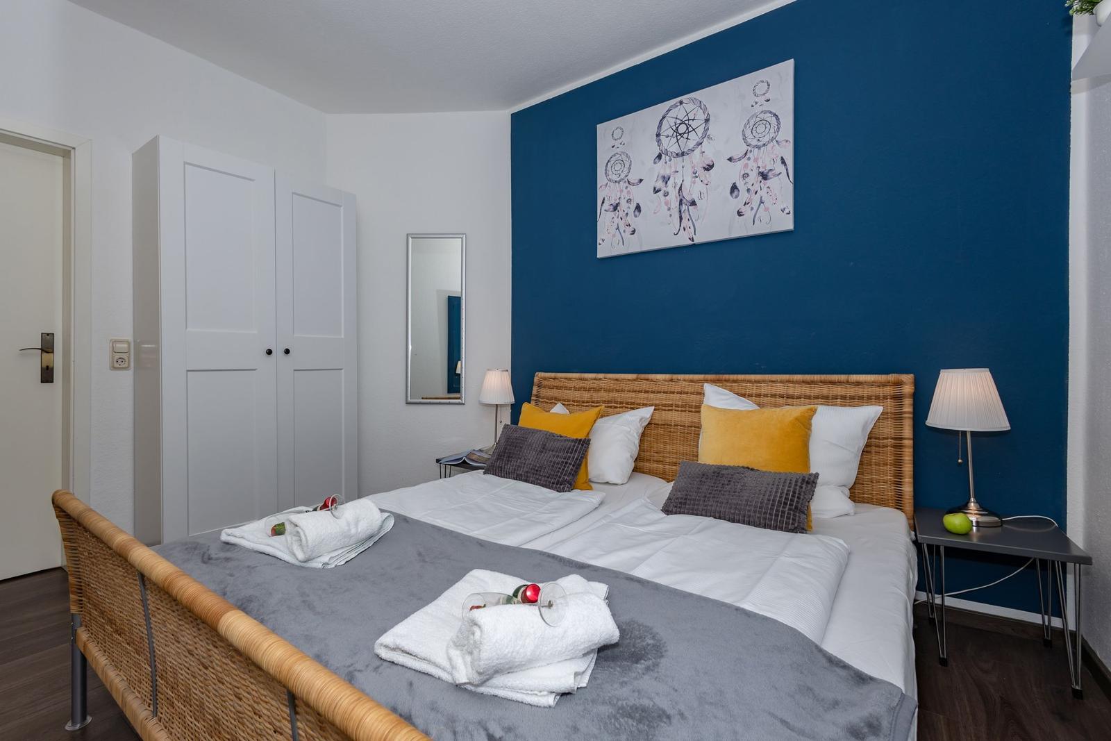 Schlafzimmer mit Bett, Nachttischen und Wandbild