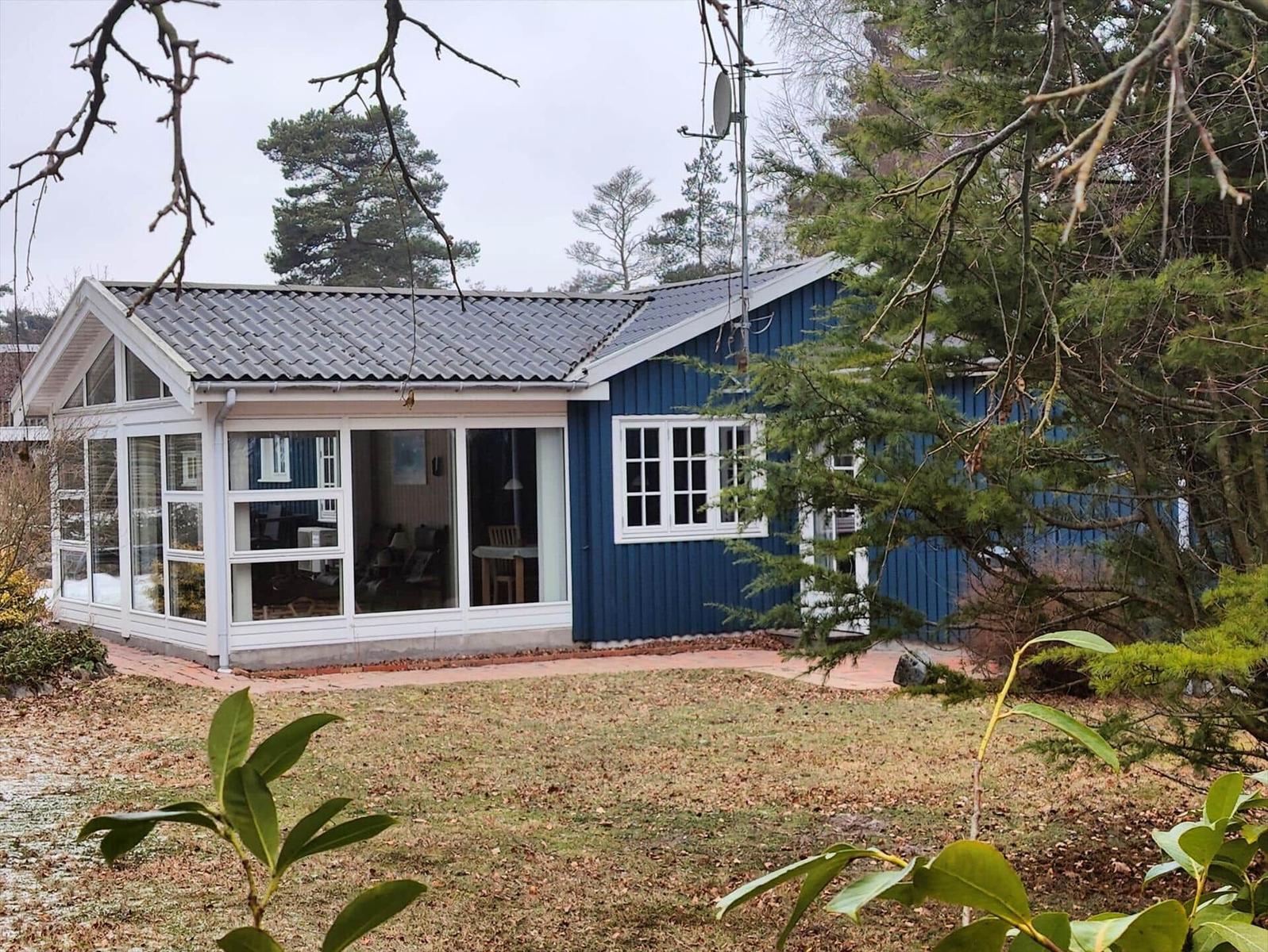Blue house with large glass area and garden