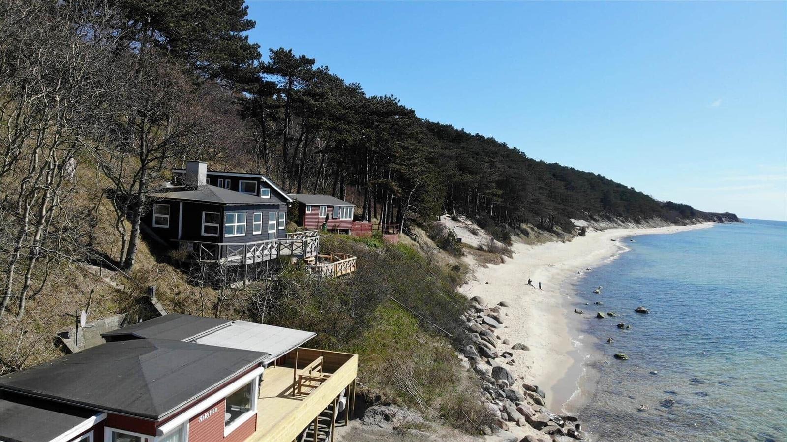 Houses by the beach with view of the sea and forest