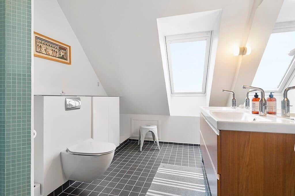 Bathroom with skylights, sink and toilet