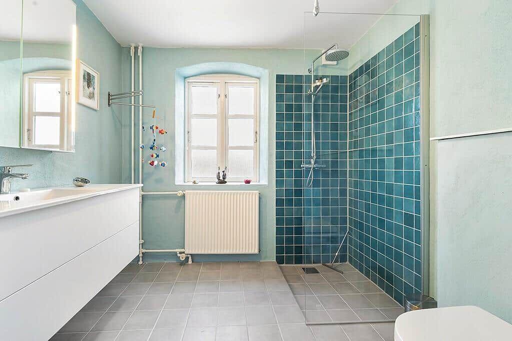 Bathroom with shower, sink, and window