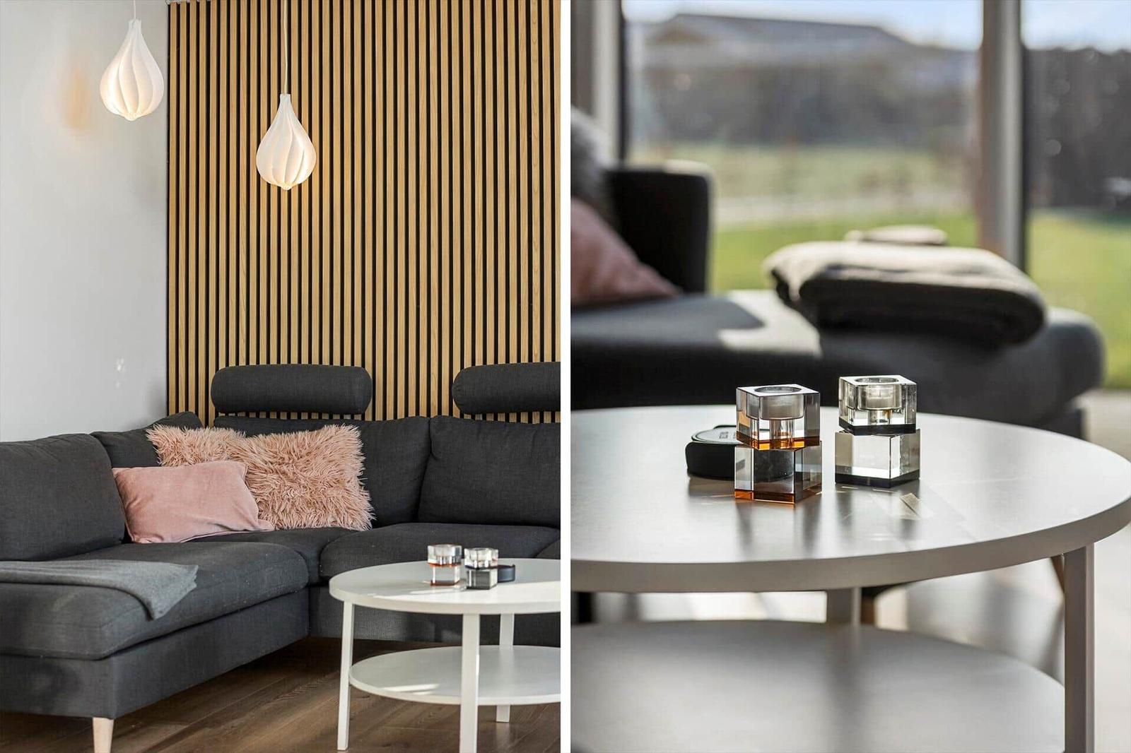 Living room with gray sofa, wooden wall, and round tables