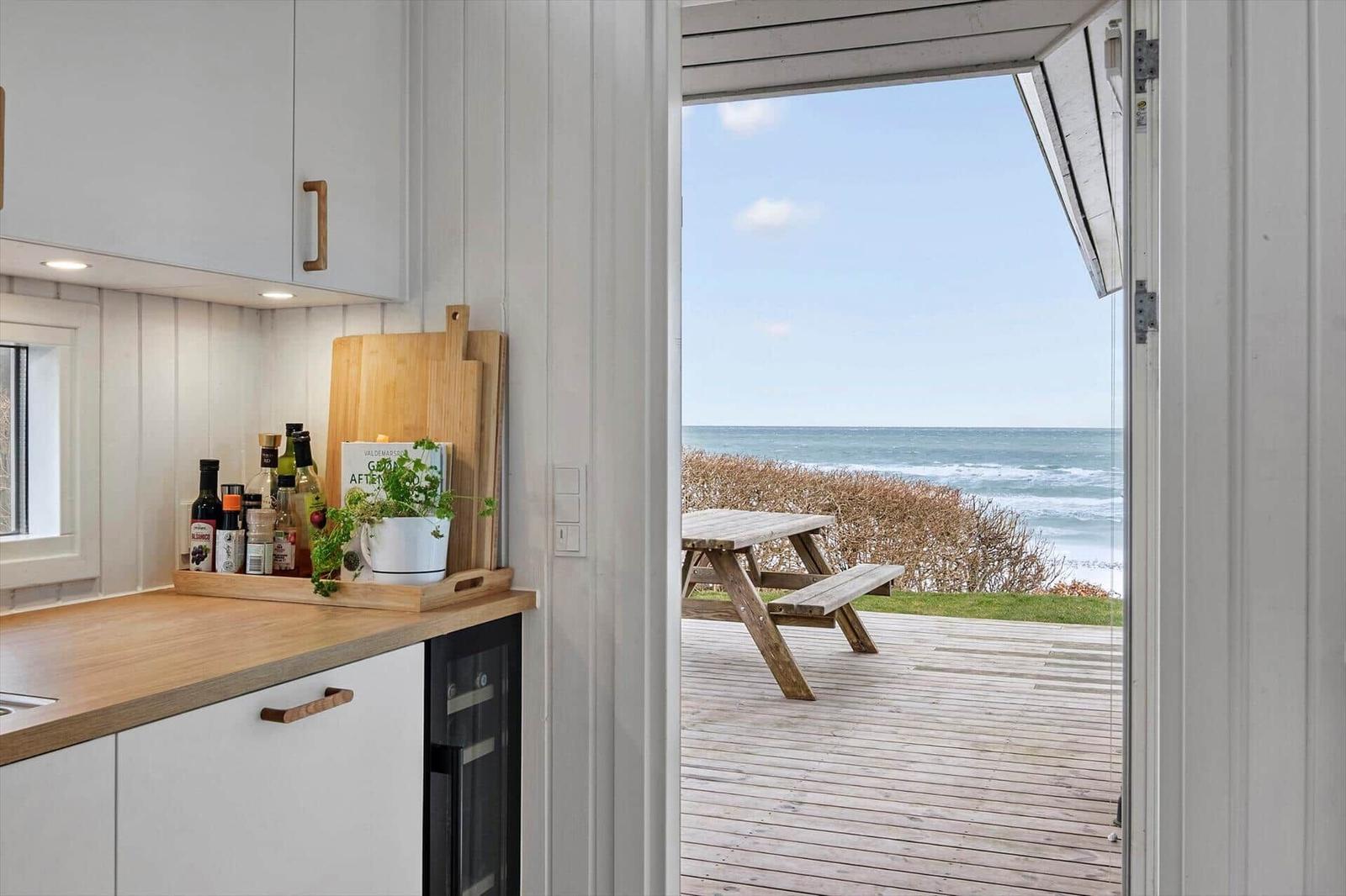 Kitchen with view of wooden terrace and sea