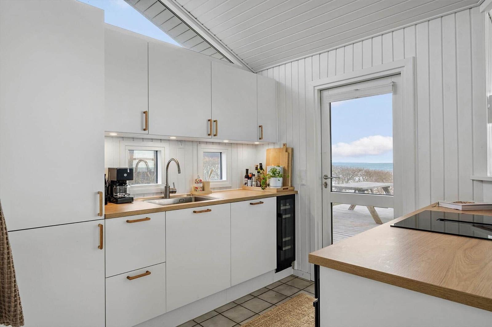 Kitchen with sea view and wooden countertops.