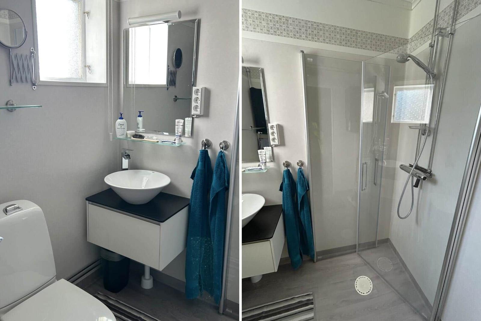 Badezimmer mit Dusche, Waschbecken und Toilette. Blaue Handtücher hängen bereit.