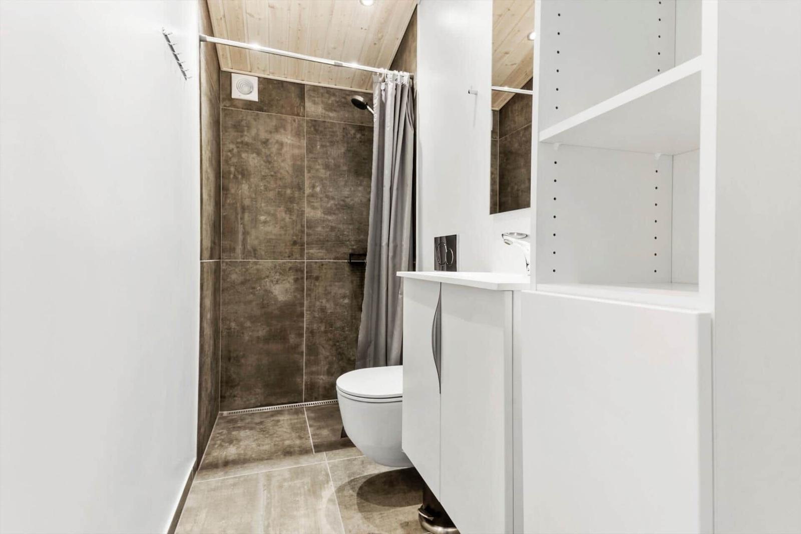 Bathroom with shower, toilet, and sink.