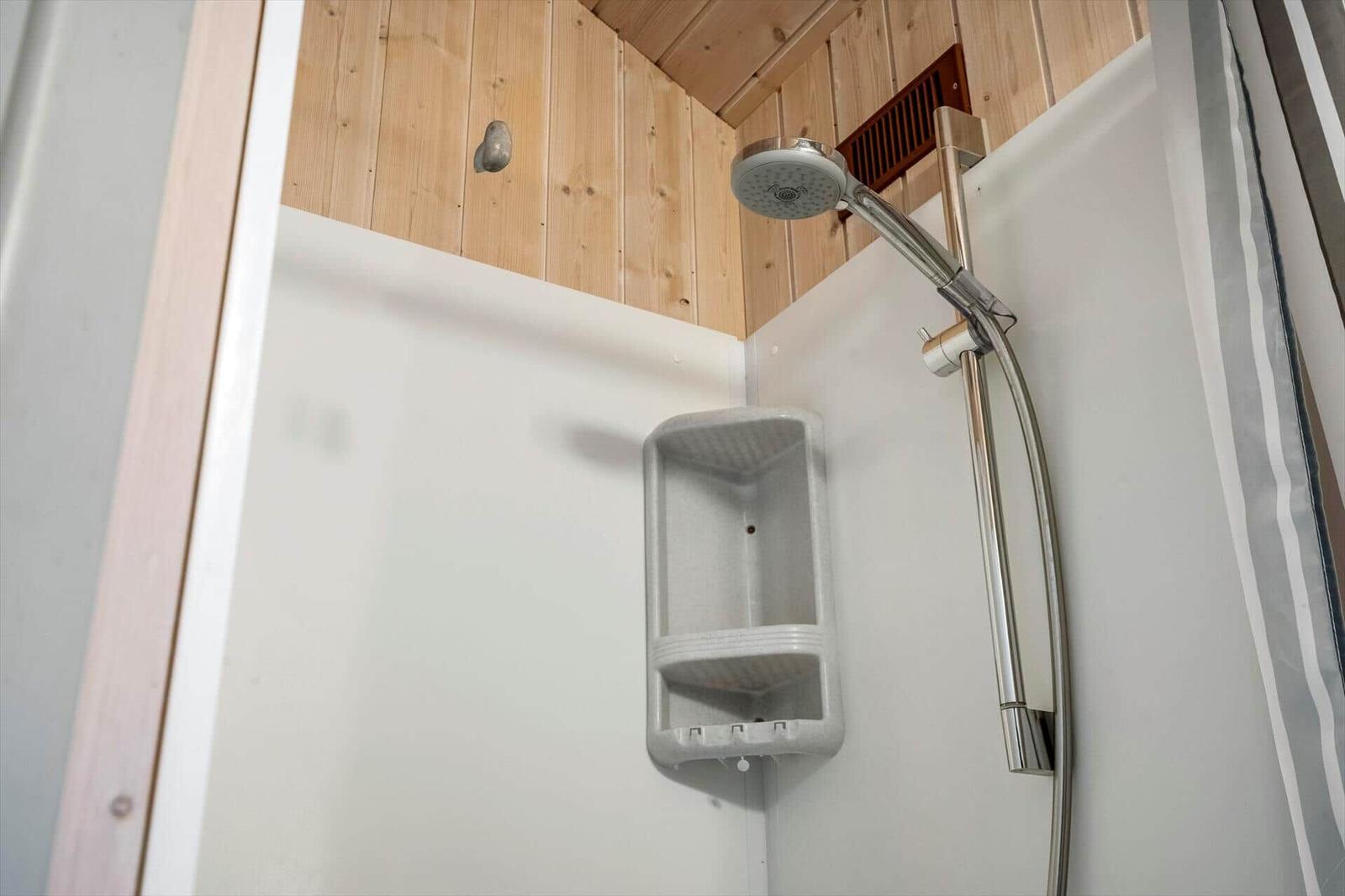 Shower cabin with shower head and shelf