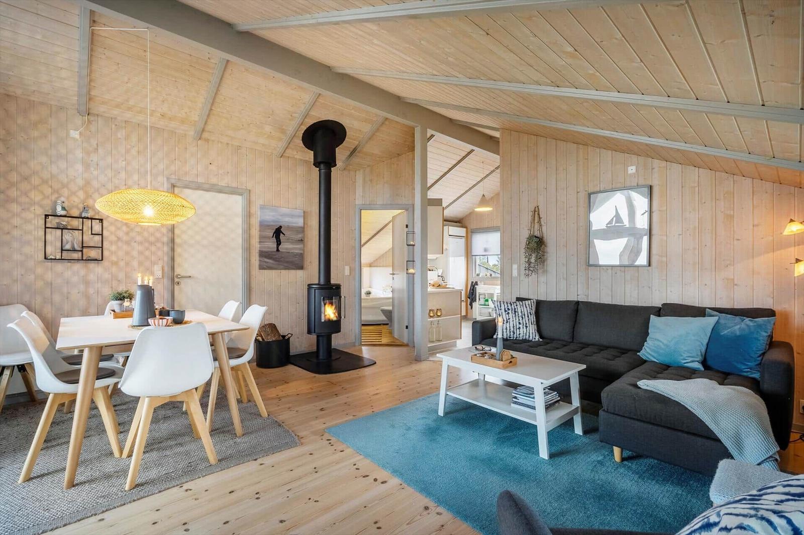 Living and dining area with fireplace, sofa, and dining table.
