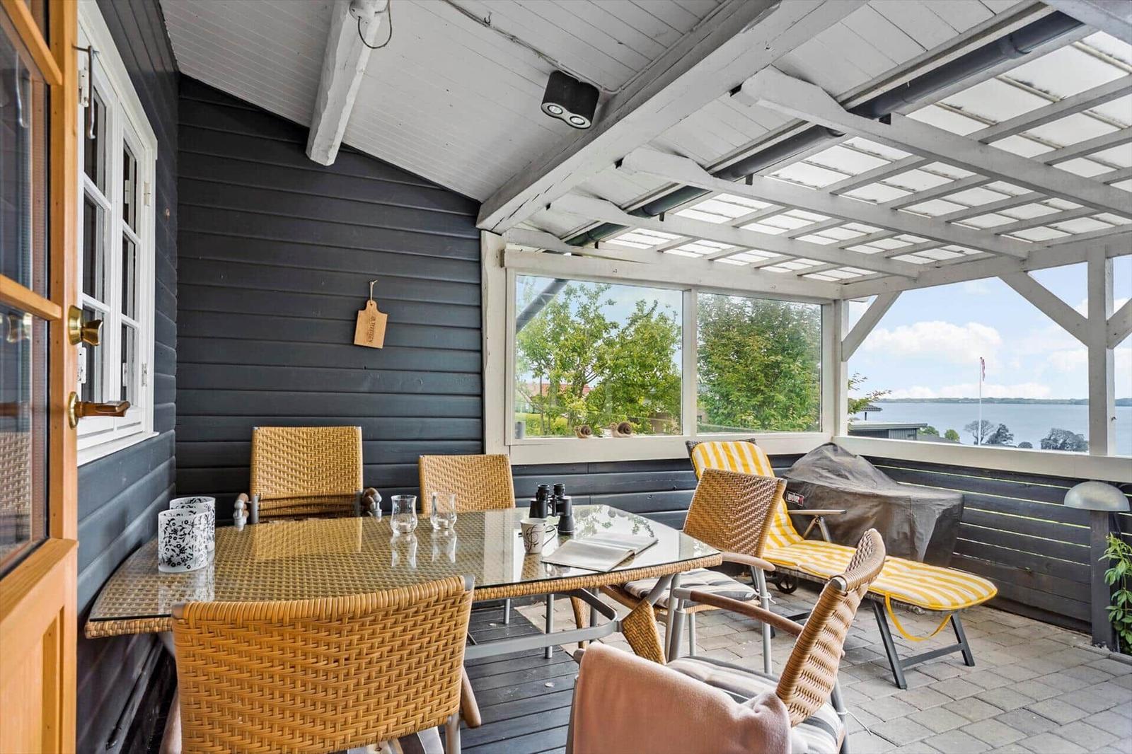 Patio with dining table, chairs, and water view