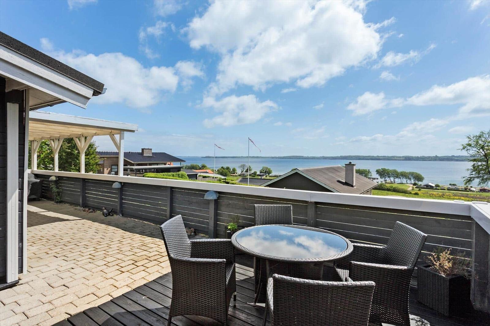 Terrace with seating area and view of sea and landscape