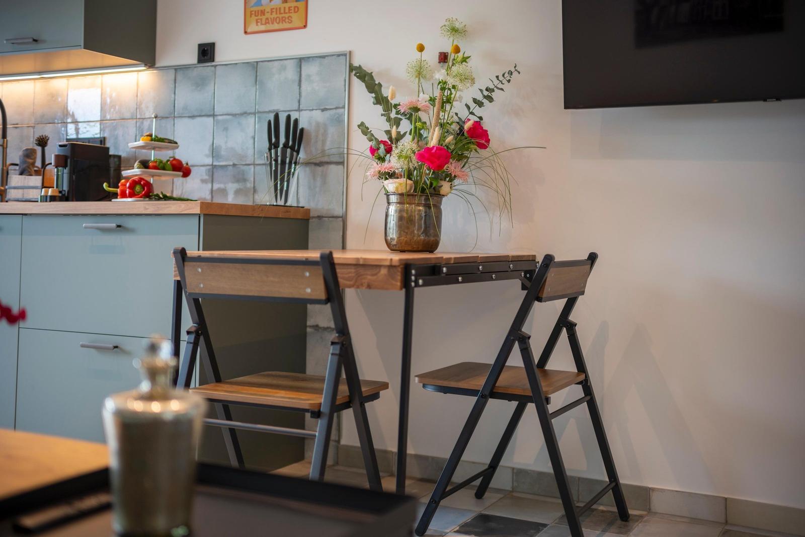 Küche mit Essplatz, Blumen und Küchengeräten