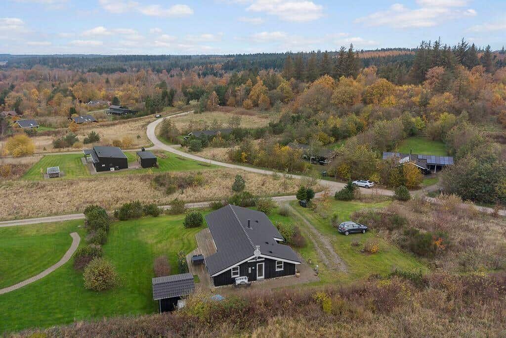 House with garden and forest in autumn