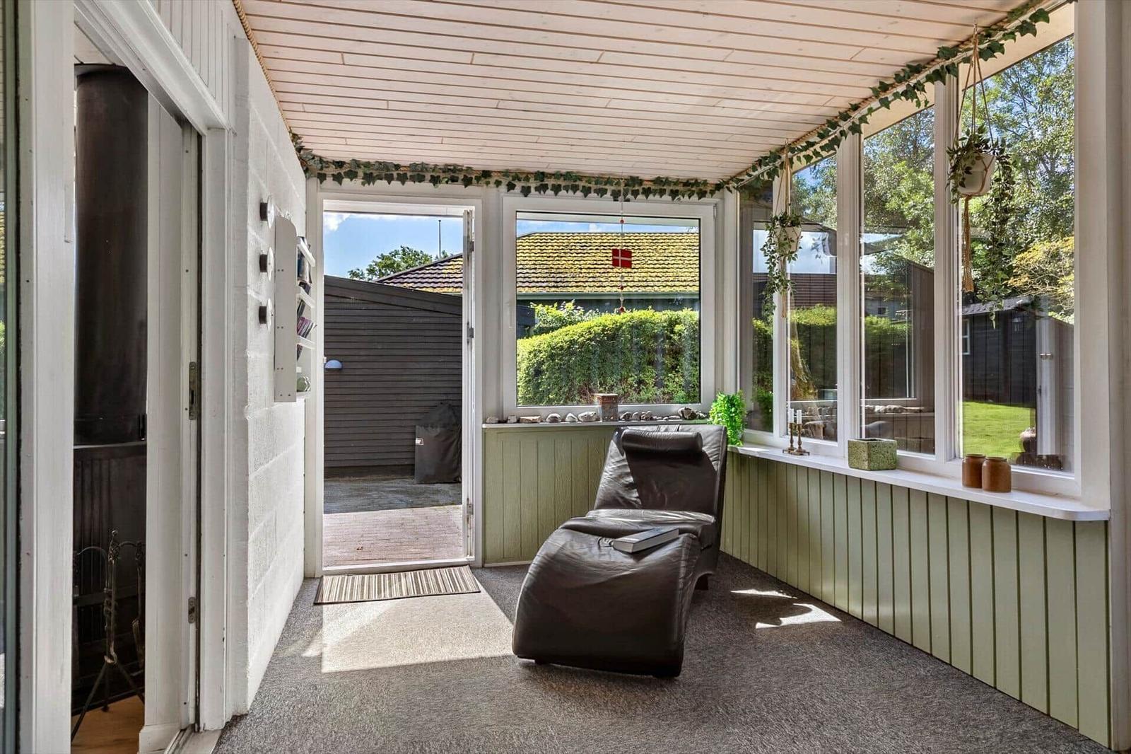 Terrace with seating and view of garden.