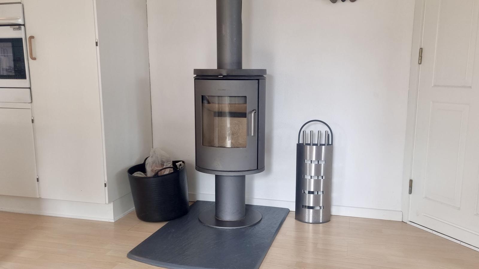 Holzofen mit Feuerstelle, Feuerzeug und Kamin im Raum