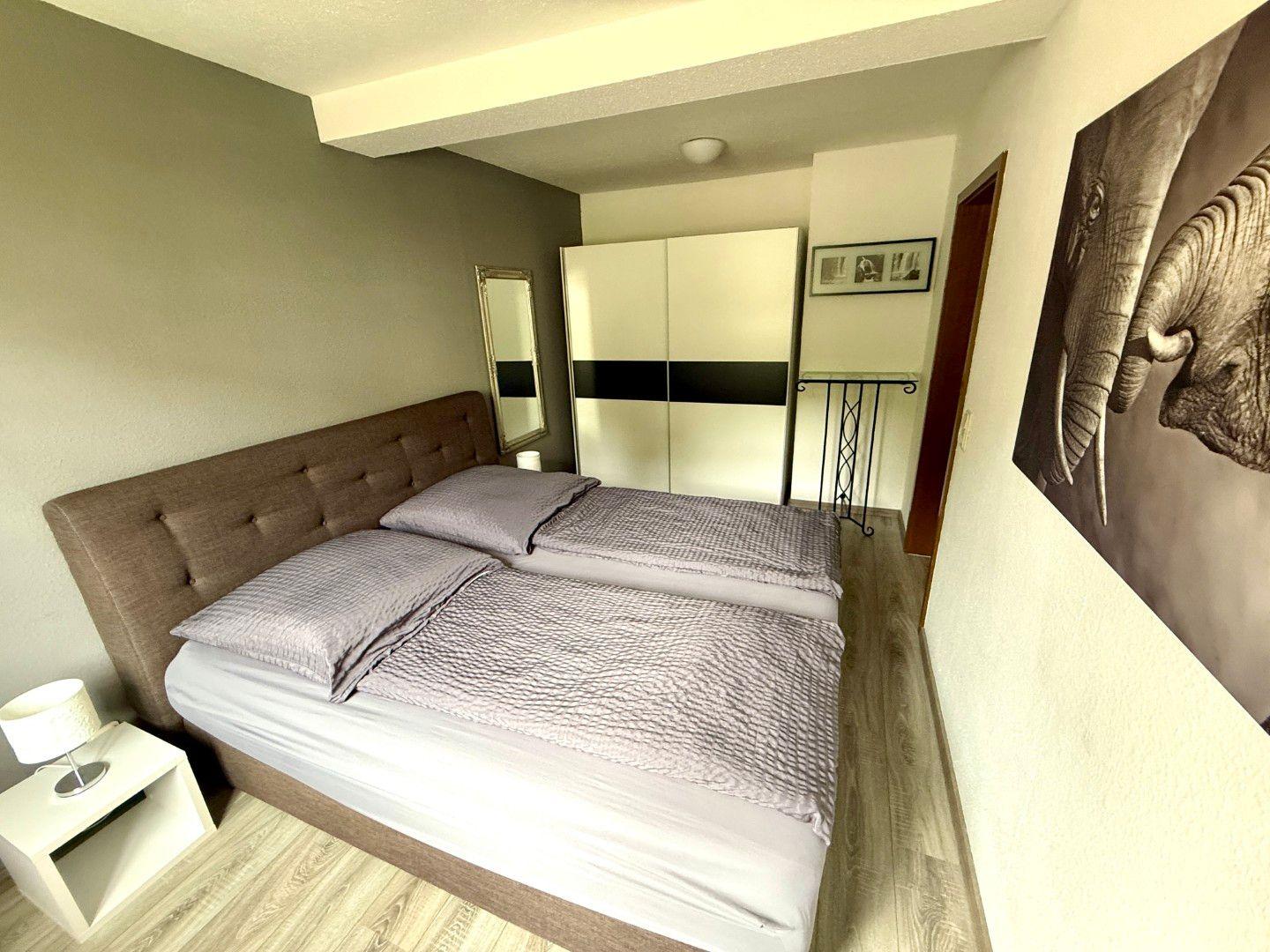 Ruhiges Schlafzimmer mit Boxspringbett in der Ferienwohnung Harztraum an der alten Stadtmauer in Blankenburg