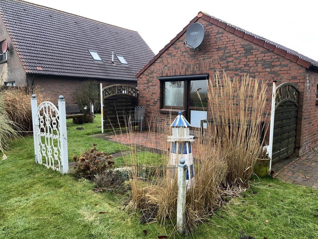 Red brick building with garden, terrace, and satellite dish.