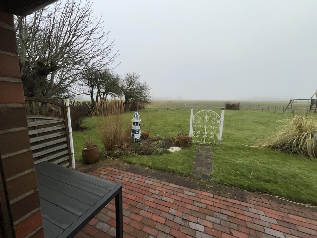 Terrace with view of green garden and white garden gate