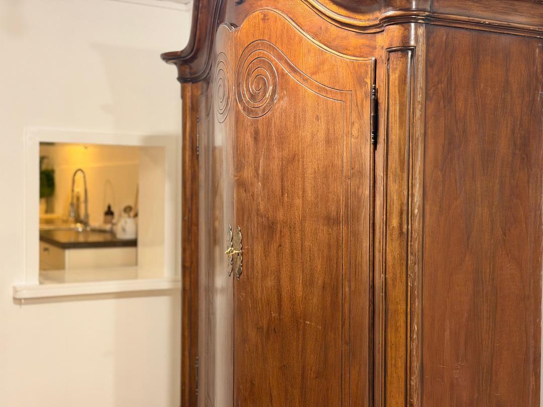 Antique cabinet with carvings, view into the kitchen