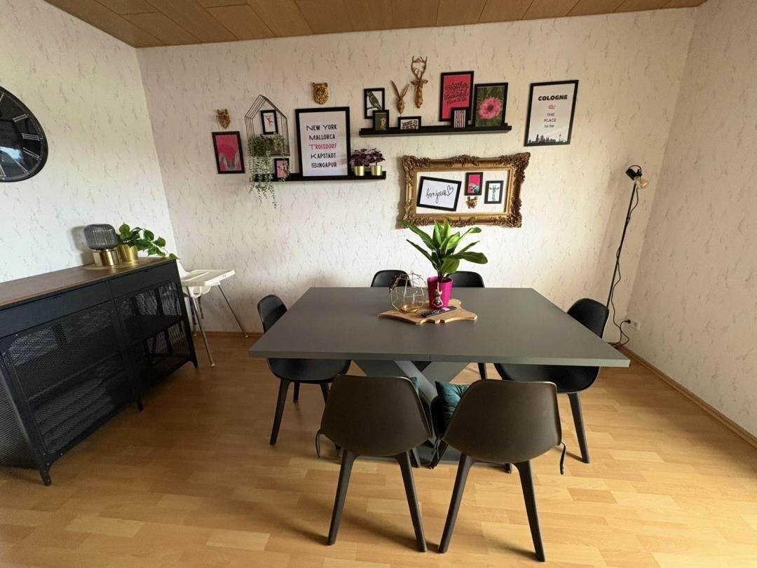 Dining room with table, chairs, and wall decor.