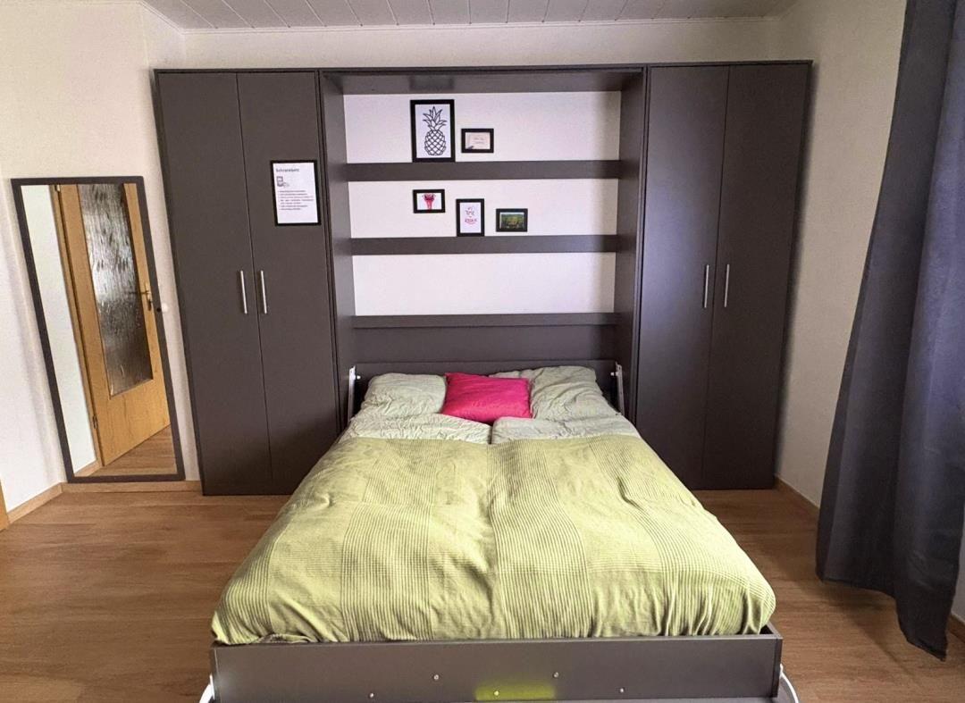 Bedroom with bed, wardrobe, and mirror