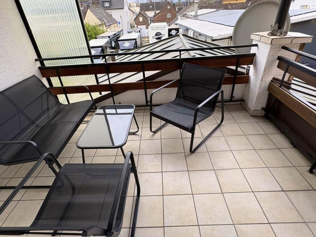 Terrace with seating group and view of rooftops