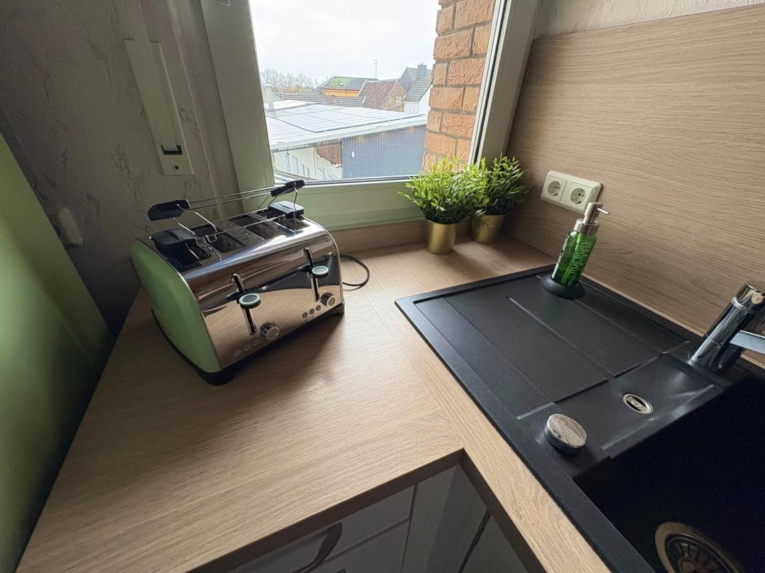 Kitchenette with toaster, sink, and window view