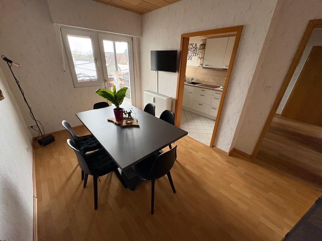 Dining area with table, chairs, and window to terrace