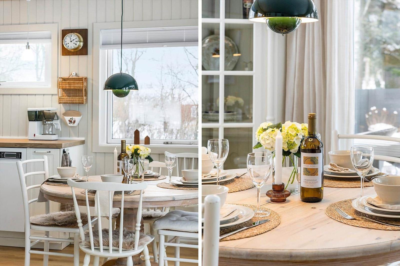 Round table with chairs, windows, and table setting.