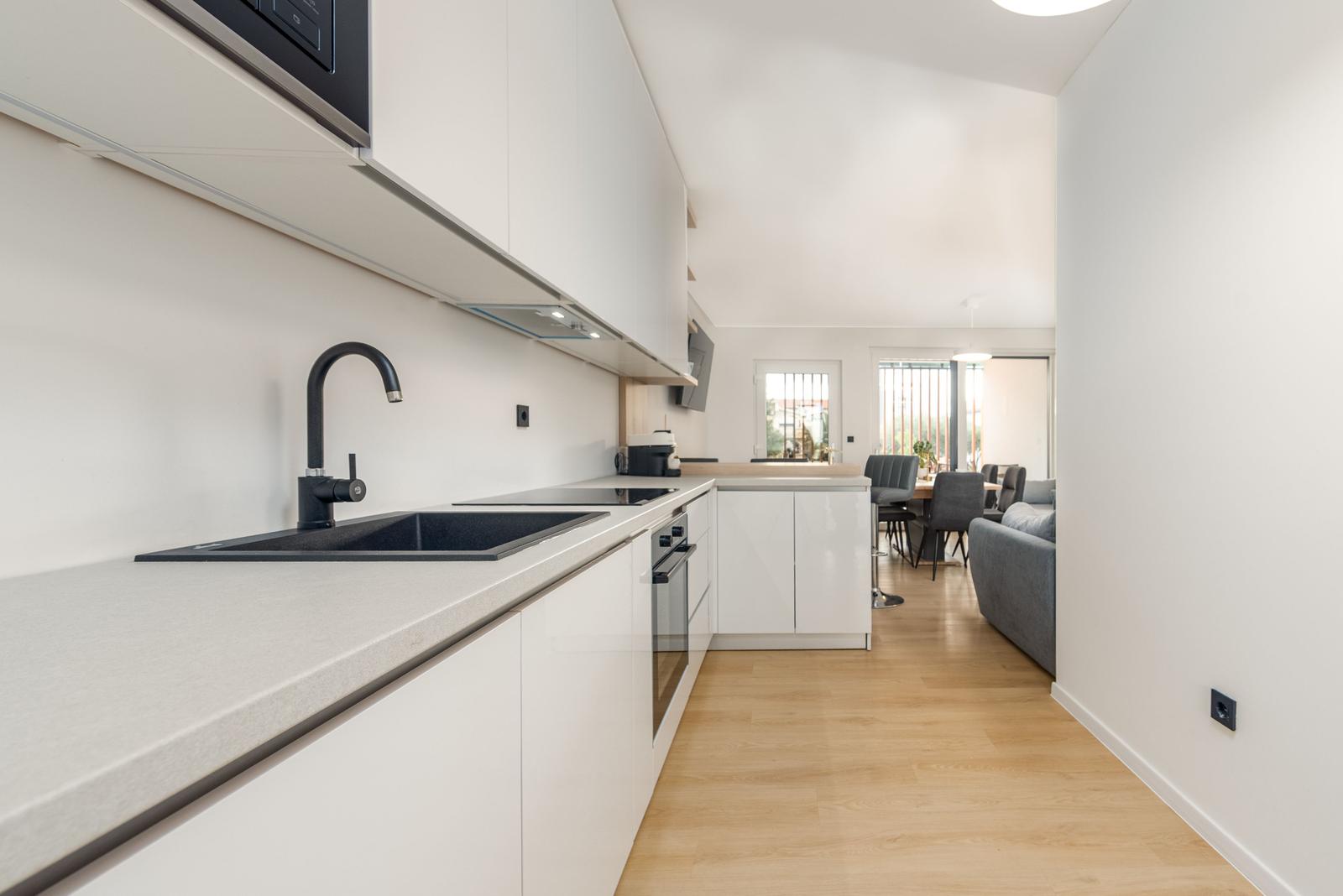 Modern kitchen with worktop and view into living area