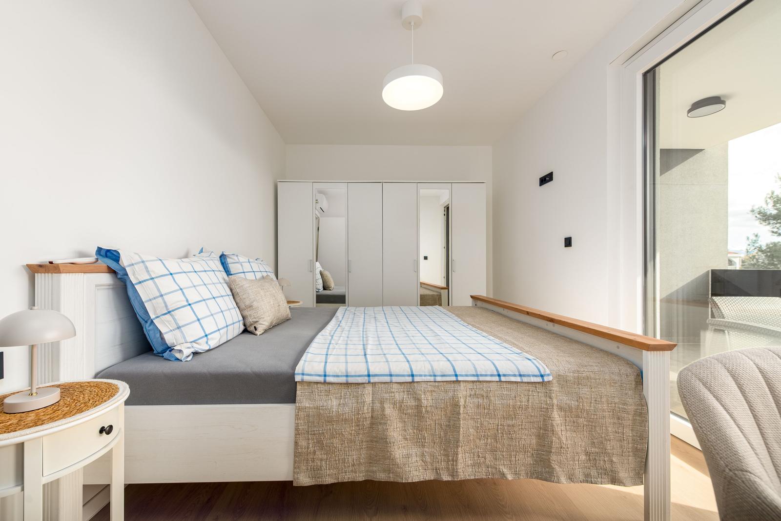 Bedroom with bed, nightstand, and bedroom furniture.