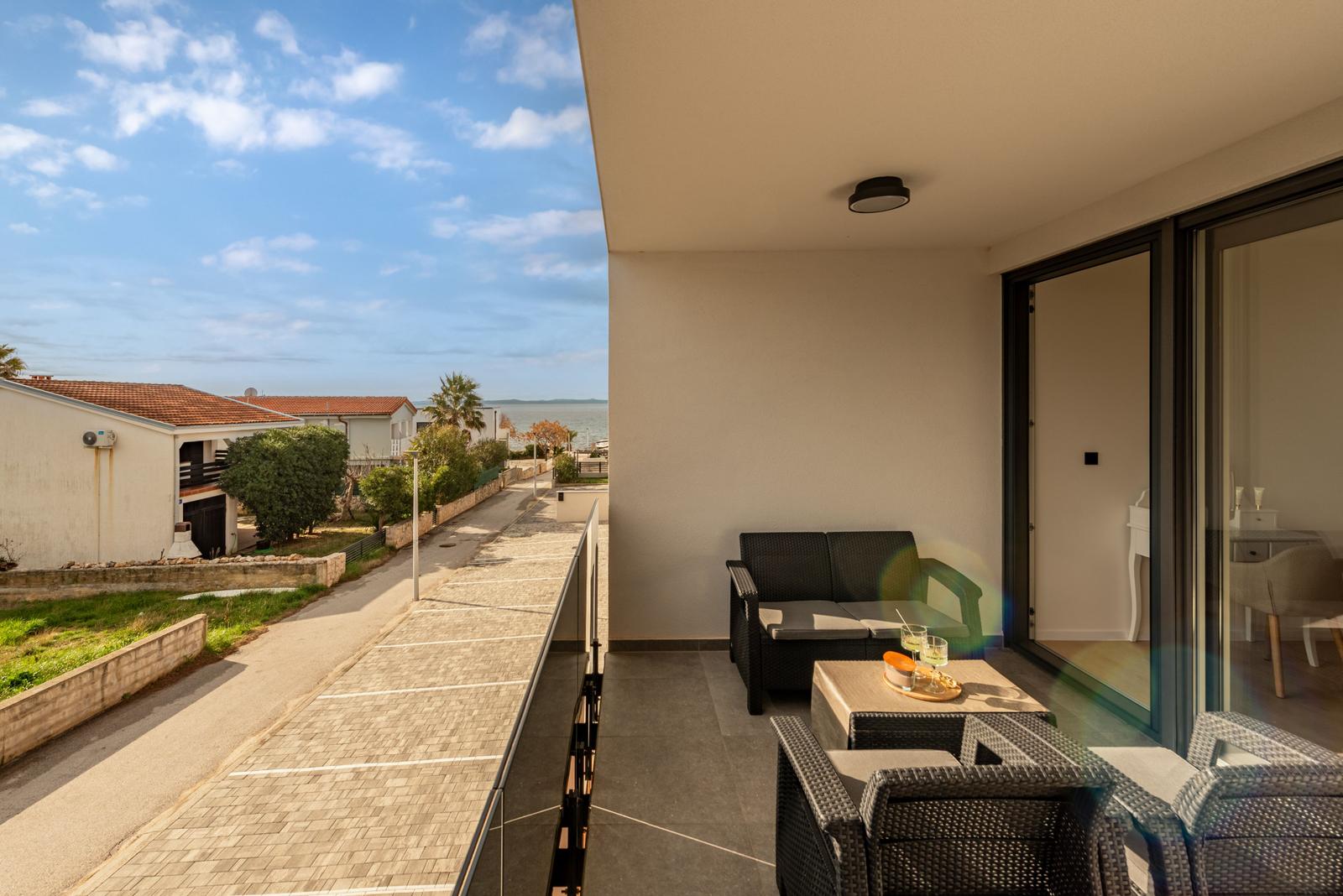Terrace with seating and view of street and sea