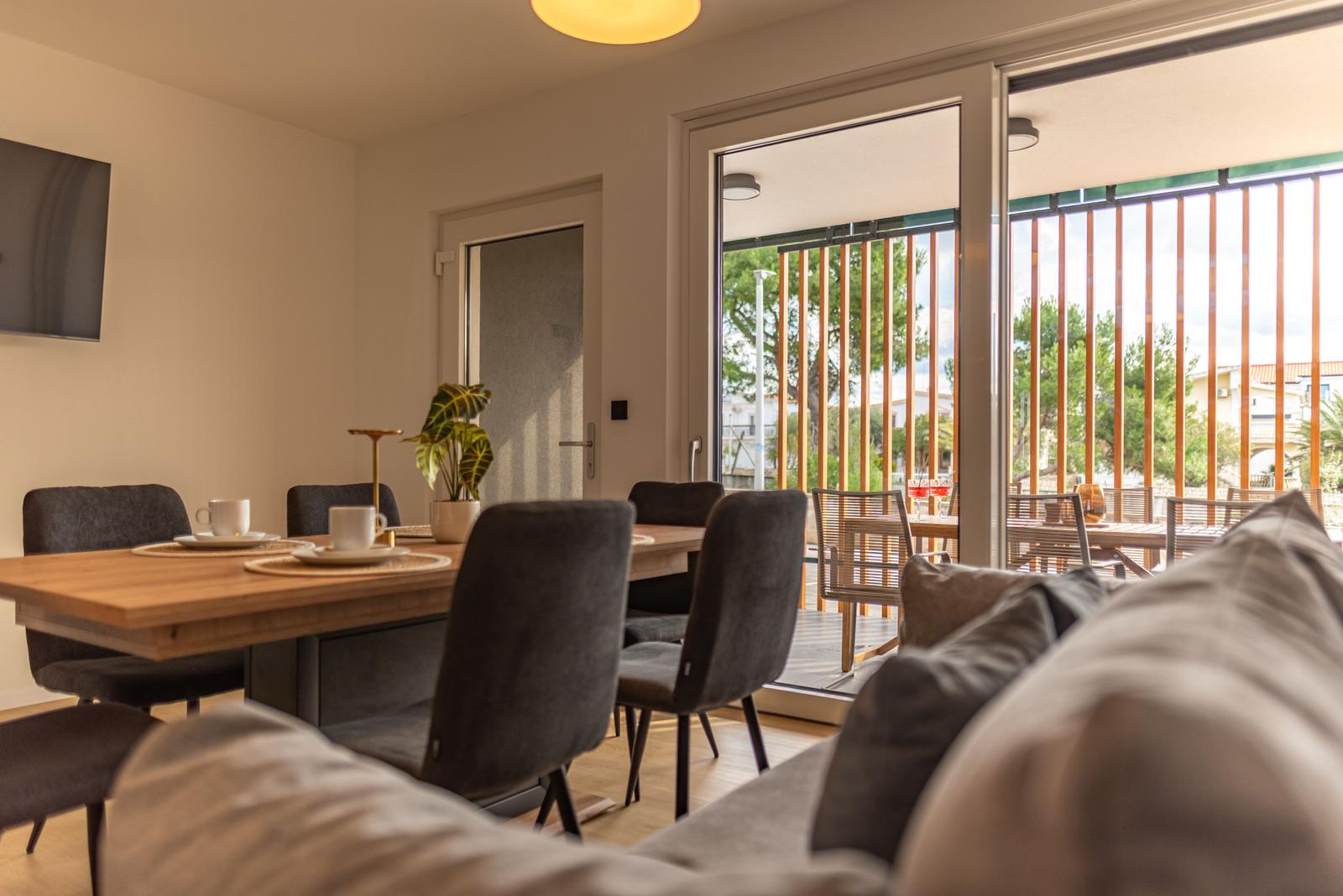 Dining room with table, chairs, and view of terrace