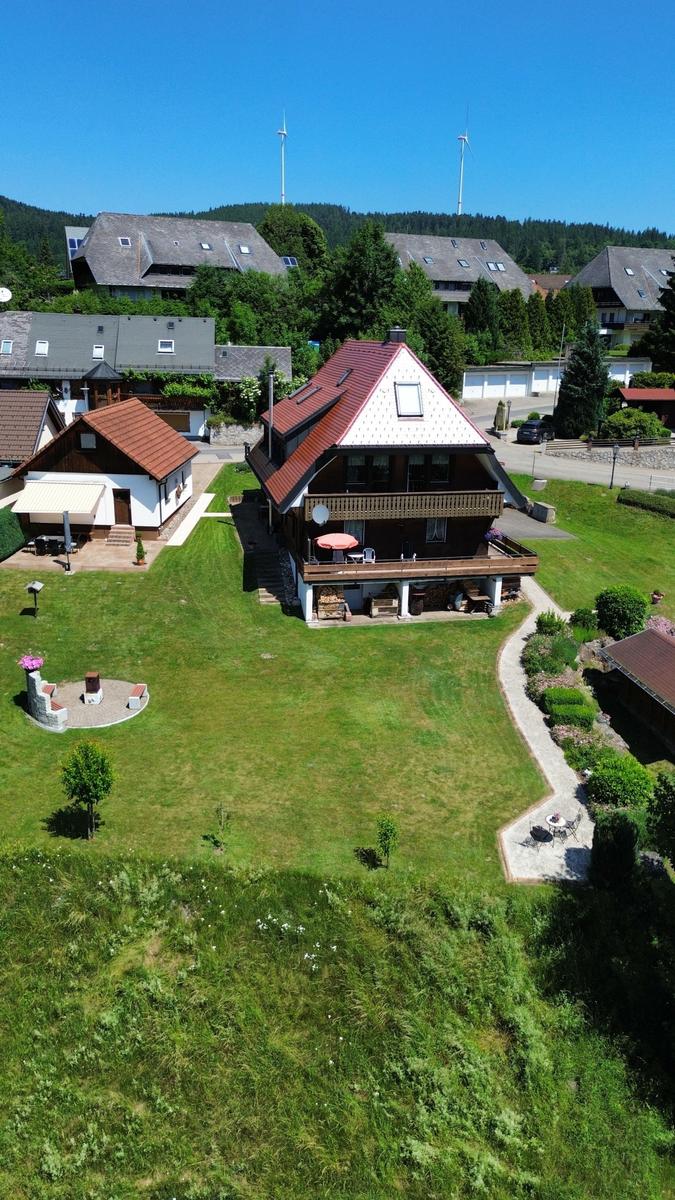 House with balcony, large garden, and view of wind turbines