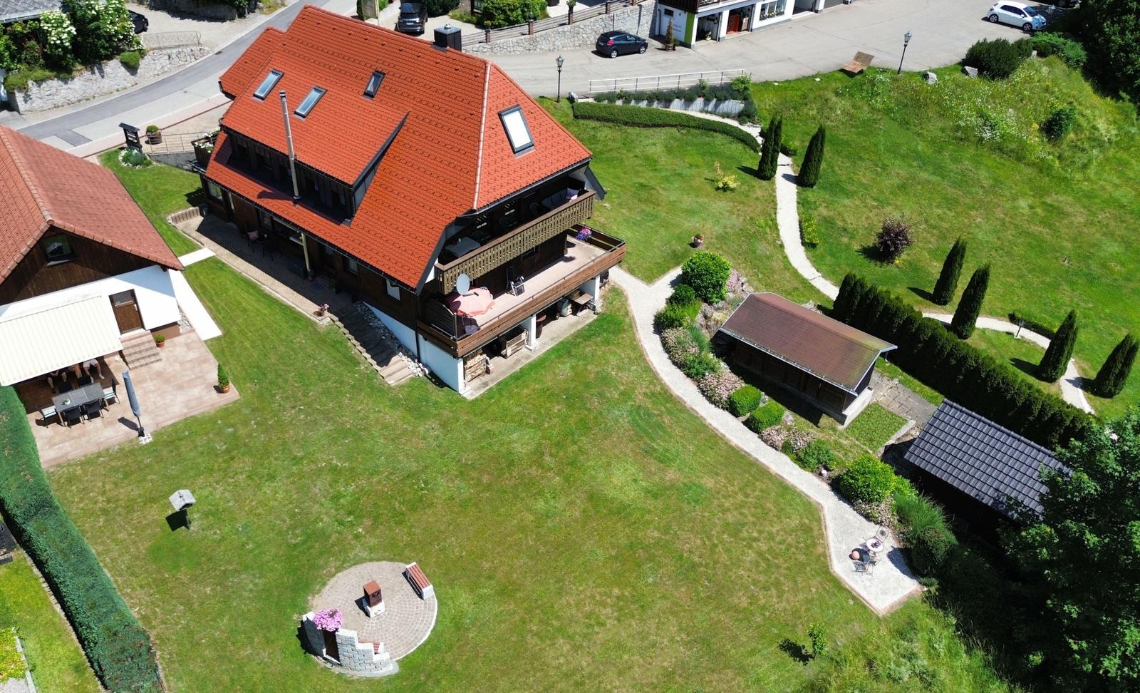 House with red roof, large garden and terrace.