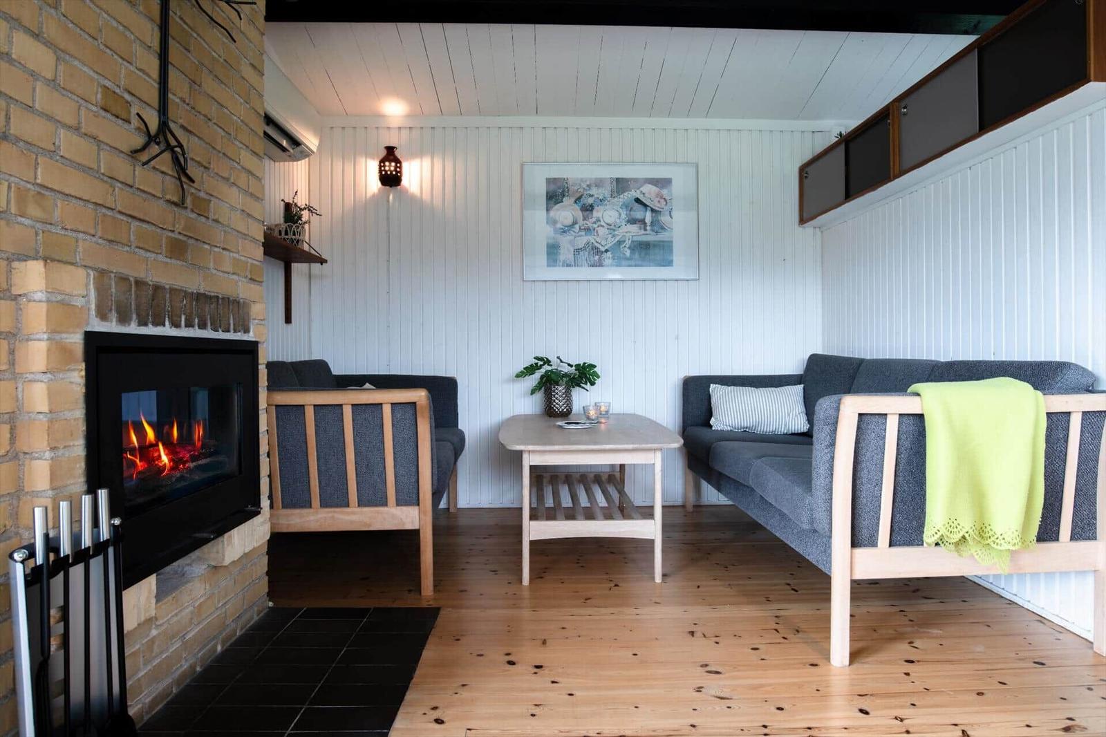 Living room with fireplace, sofa, and table