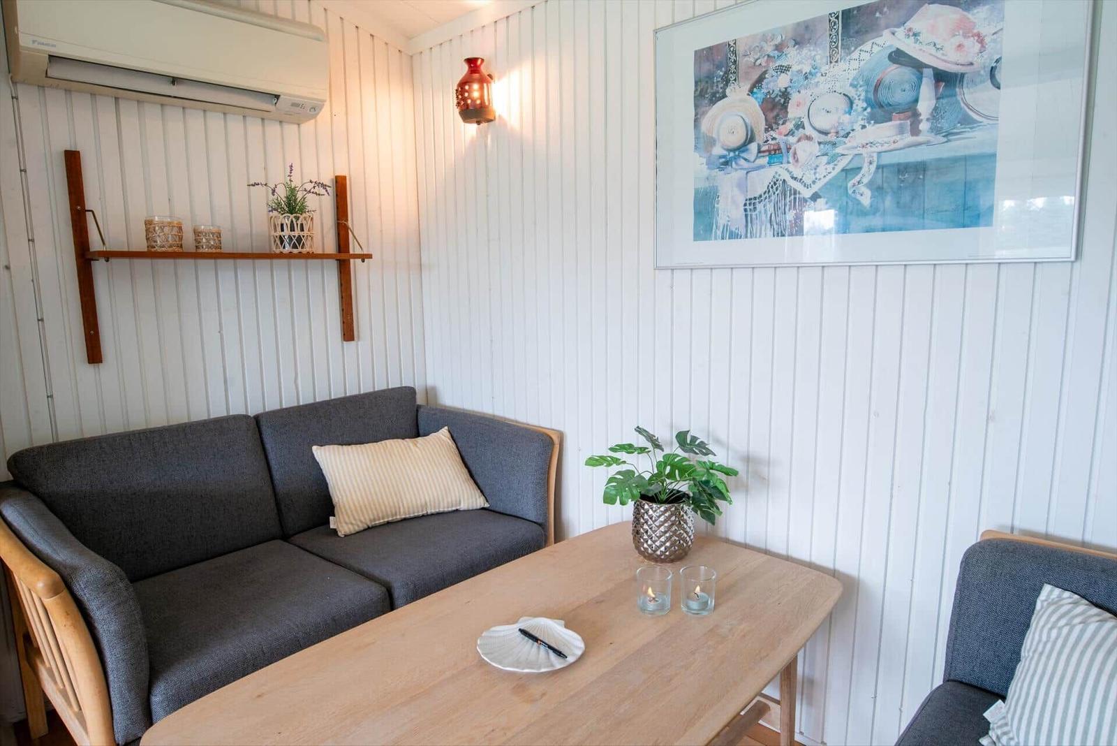 A living area with sofa, table, and wall art.