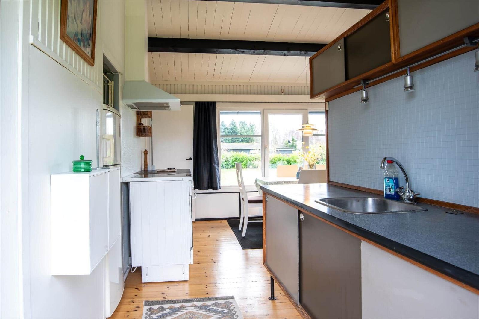 Kitchen with countertop, sink, and window view