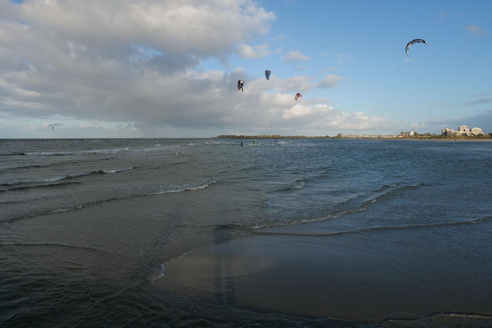 Kitesurfer auf dem Meer unter bewölktem Himmel