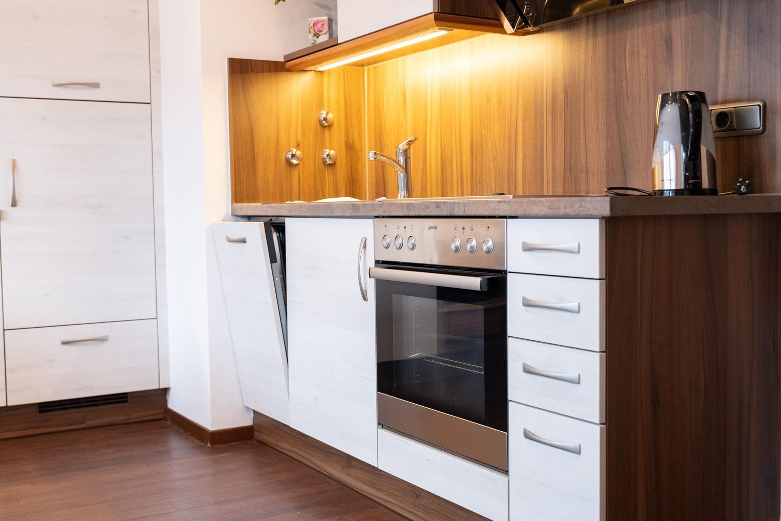 Küche mit Edelstahlherd, Spüle und Kaffeemaschine