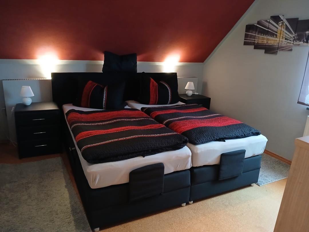 Bedroom with double bed, nightstands, and wall art