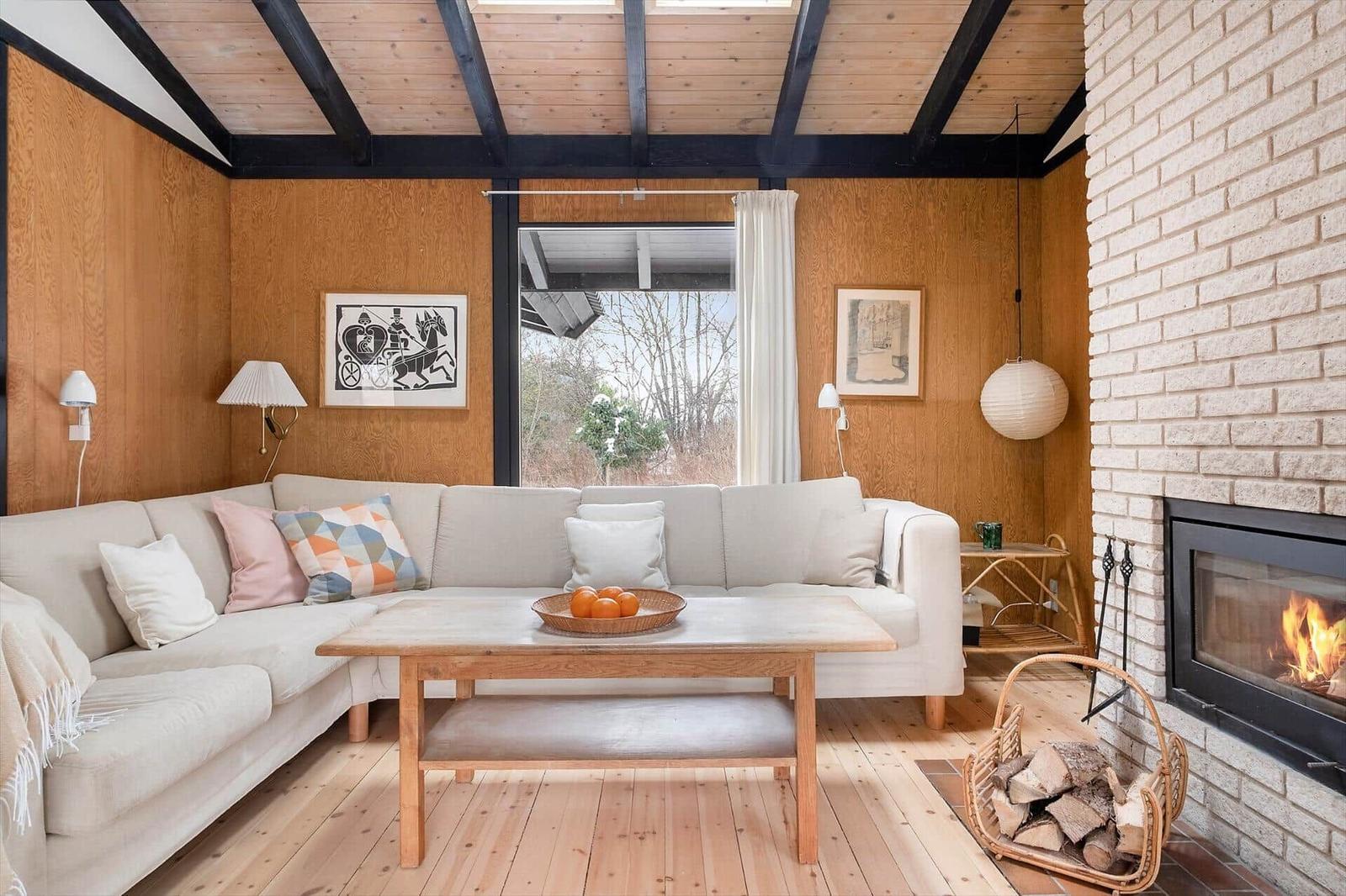 Living room with sofa, fireplace, and wooden floor.