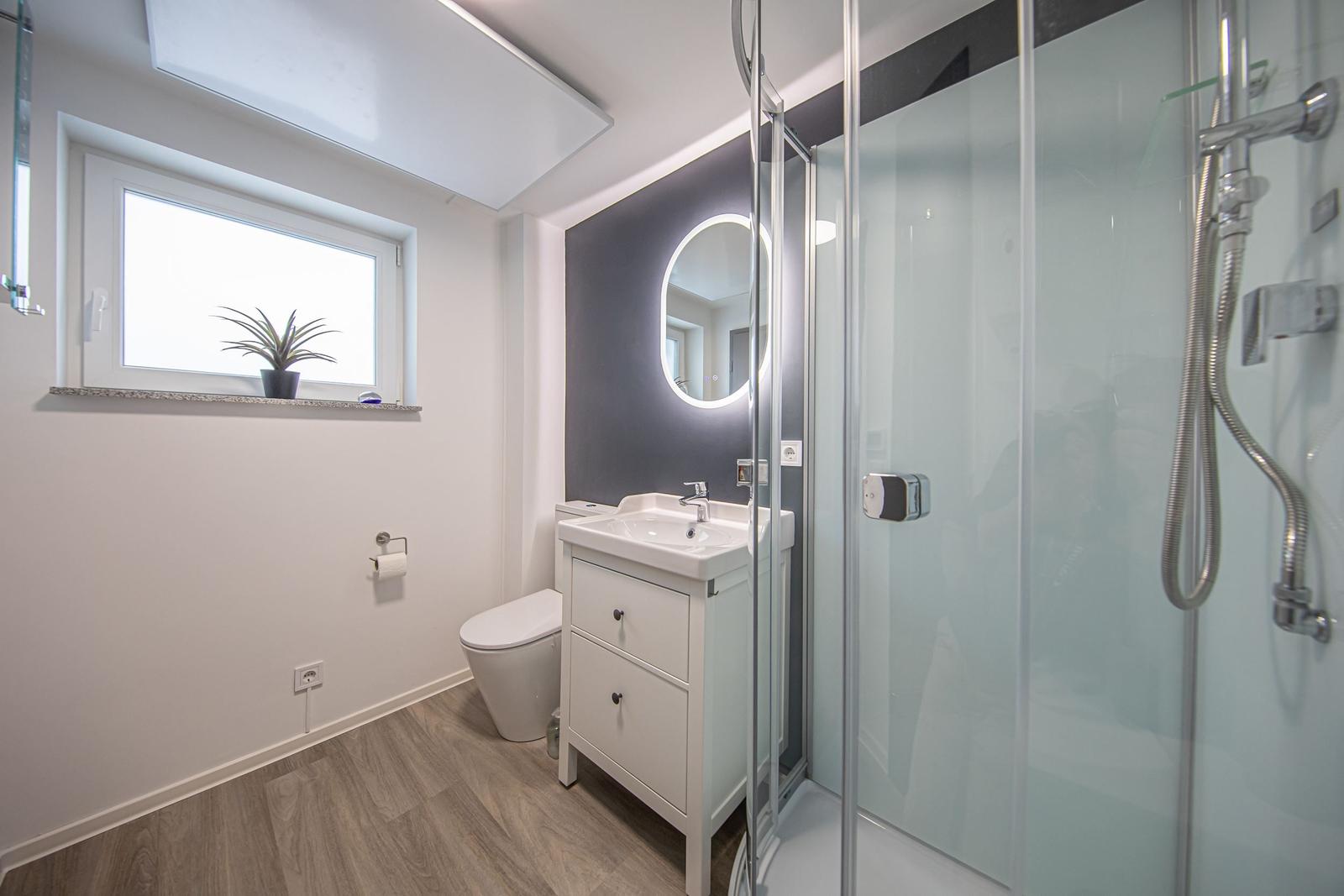 Dusche, natürliches Tageslicht und ein modernes Waschbecken...