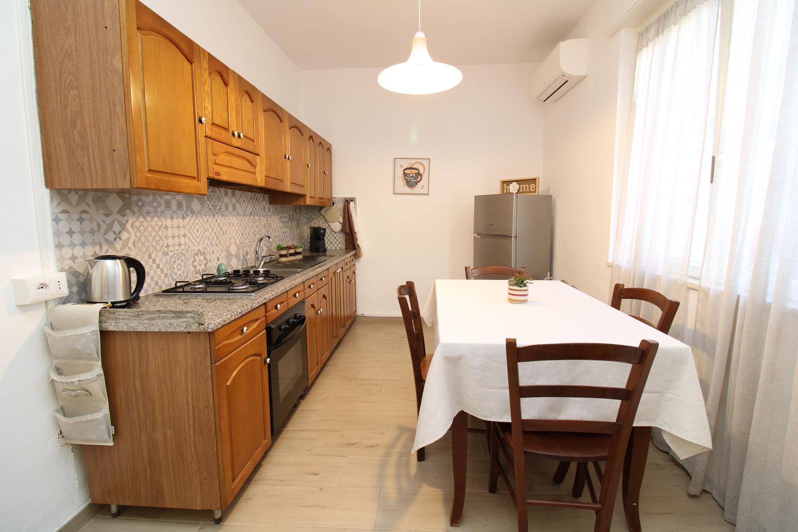 Kitchen with wooden cabinets, dining table, and kitchen counter.