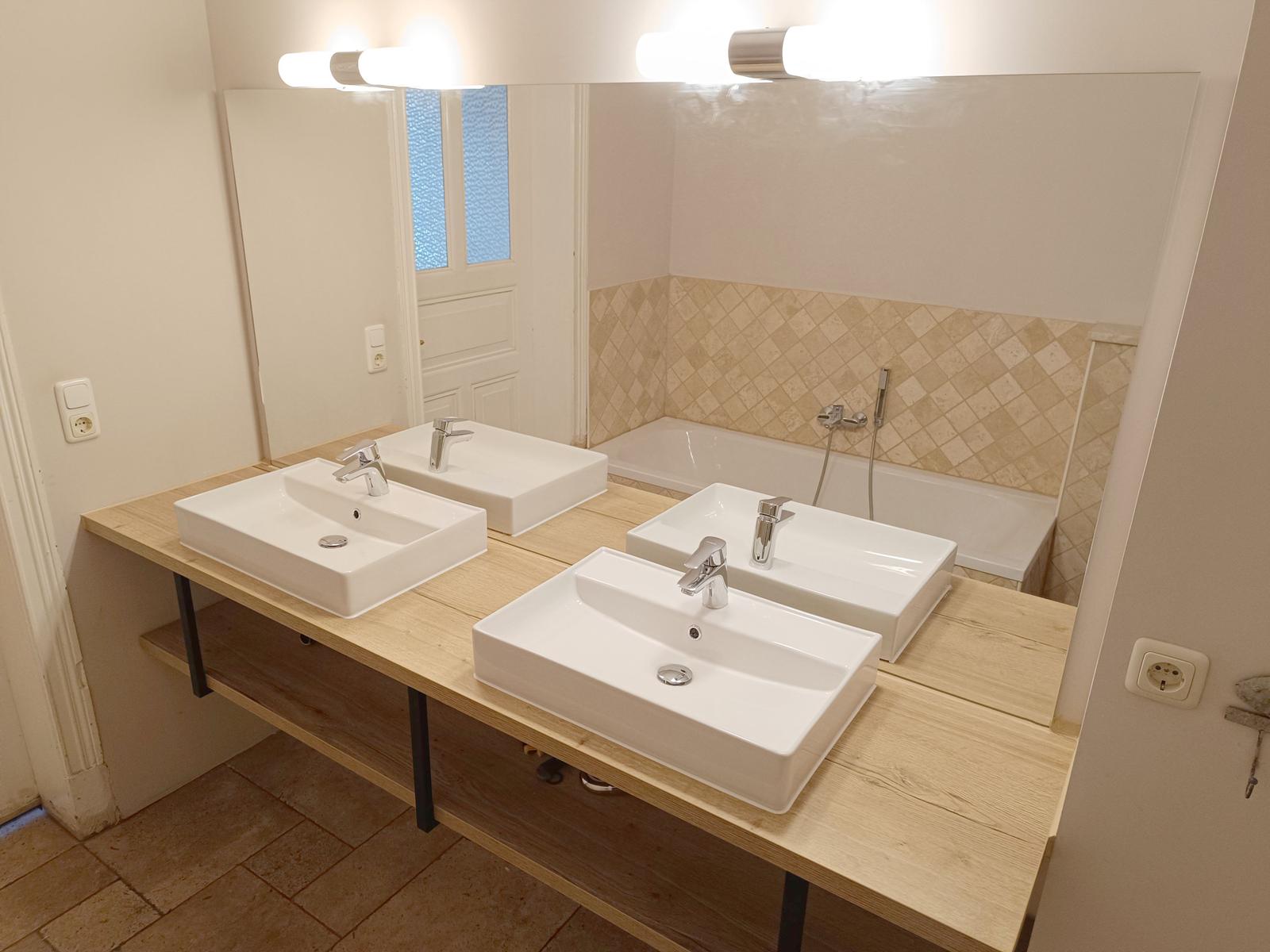 Badezimmer mit zwei Waschbecken, Spiegelschrank und Badewanne.